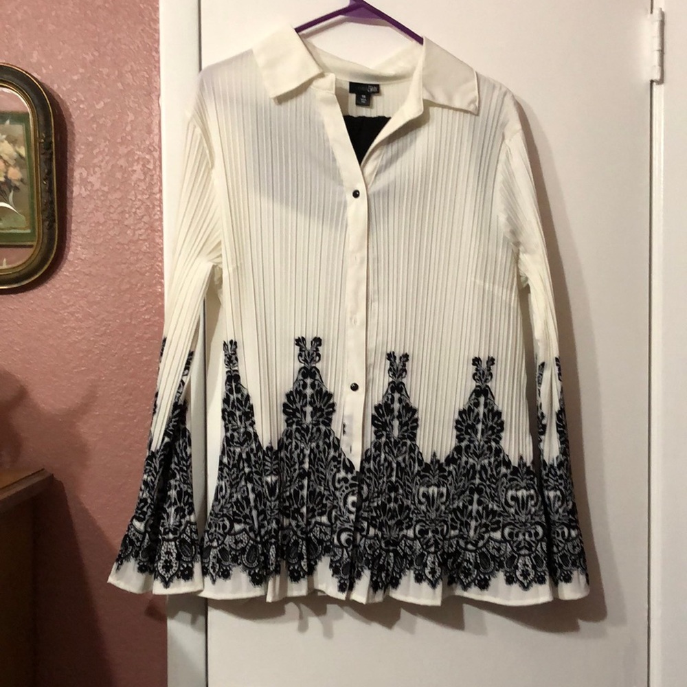 Cream ribbed black lace look print on bottom. Polyester with bell sleeves